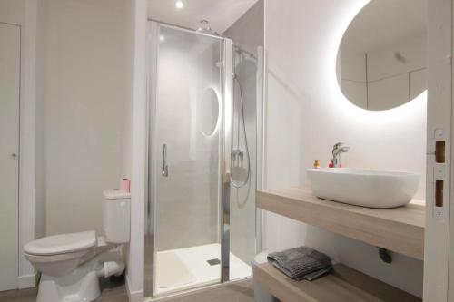 a white bathroom with a sink and a toilet at Gîte G40 in Marchésieux