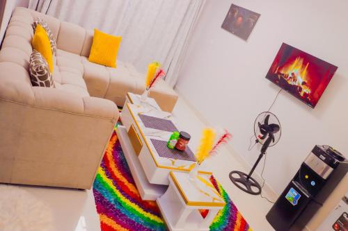 a living room with a couch and a rainbow rug at Maggy Homes in Marimbeti