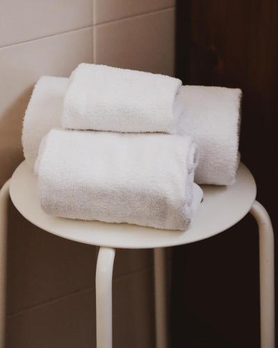 a pile of white towels on a white plate at La Foresteria in Mola di Bari