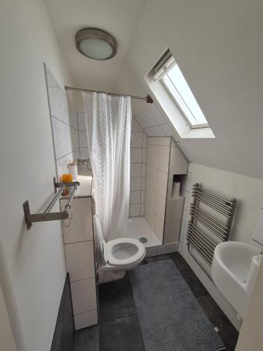 a small bathroom with a toilet and a sink at Studio At C in Zandvoort