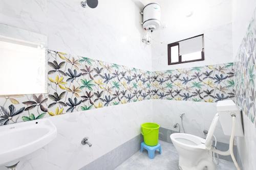 a bathroom with a white toilet and a sink at Premium-Ram-Krishna-Palace in Ayodhya