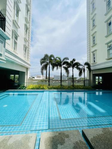 a swimming pool in the middle of a building at Saint Honore - La Casa De Khea in Sampong