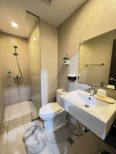 a bathroom with a toilet and a sink and a shower at Saint Honore - La Casa De Khea in Sampong