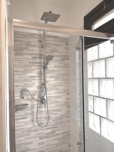 a shower in a bathroom with a glass door at Spacious, renovated apartment in the centre in Montecatini Terme