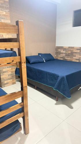 a bedroom with a bunk bed and a ladder at Espaço Beatriz in Aparecida