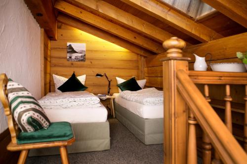 a bedroom with two beds in a wooden cabin at Chalet am Frohmarkt in Oberstdorf