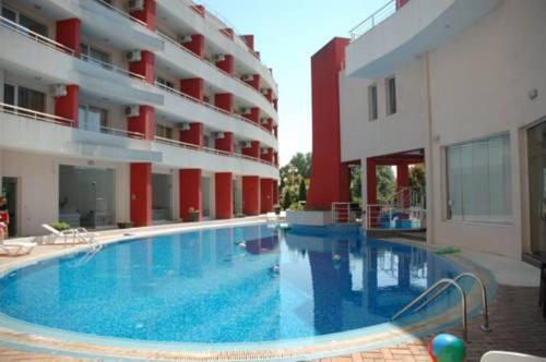 a large swimming pool in front of a building at Apartments Victoria in Kranevo