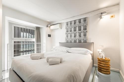 a bedroom with a large white bed with a window at Elisabeth s Loft in Milan