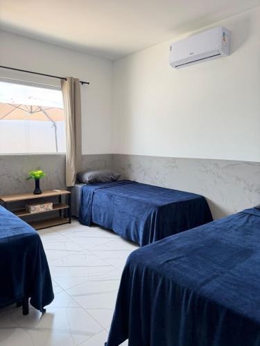 a room with two beds and a window at Casa Privativa Jacuzzi em Linhares in Linhares