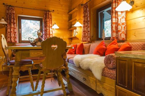 a living room with a couch and a table at Romantisches Berg-Chalet in Bayrischzell