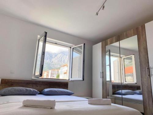 a bedroom with two beds and two windows at Central nude oasis in Makarska