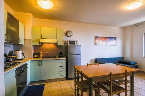 a kitchen with a table and a dining room at Vista Mare in Sassonetto