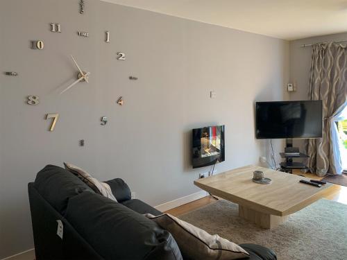 a living room with a couch and a coffee table at Crossburn Hideaway in Helensburgh