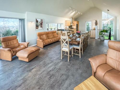 a living room with a table and a dining room at Grey Rocks House in Kippford