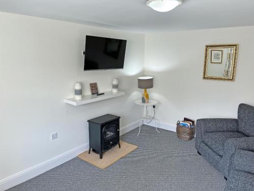 a living room with a couch and a fire place at Rose Cottage - Uk51373 in Winston