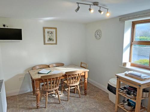 a dining room with a wooden table and chairs at Rose Cottage - Uk51373 in Winston