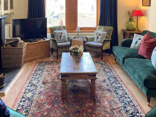 a living room with a couch and a coffee table at Aldersyde in Tighnabruaich