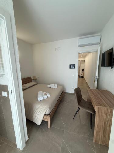 a bedroom with a bed and a table in it at Chiara 2 in Cairo Montenotte