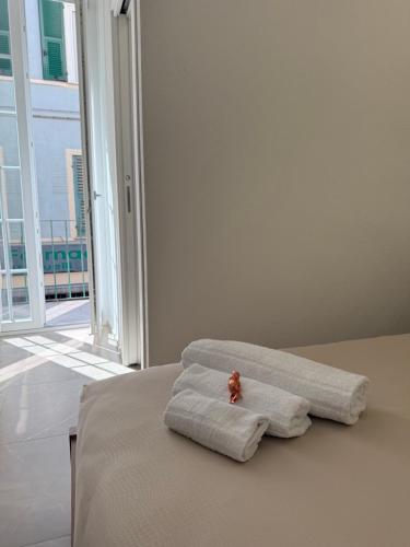 a bed with two towels and a teddy bear on it at Chiara 2 in Cairo Montenotte