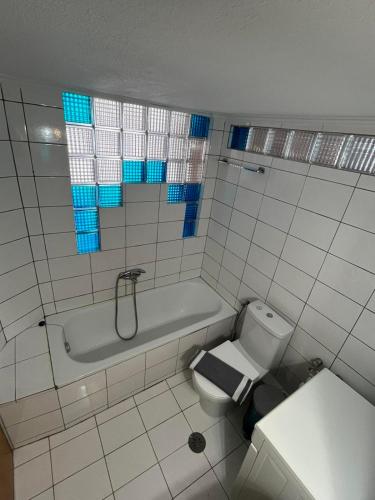 a bathroom with a tub and a toilet and a sink at Peramos Luxury 2 in Nea Peramos