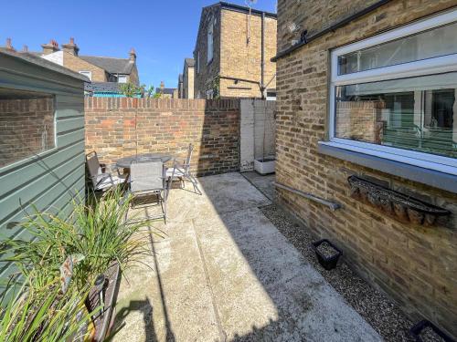 a patio with chairs and a table and a building at Newington House in Ramsgate