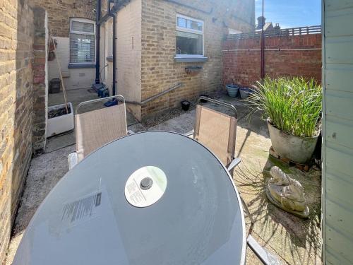a table and two chairs in a backyard with a table and chairs at Newington House in Ramsgate