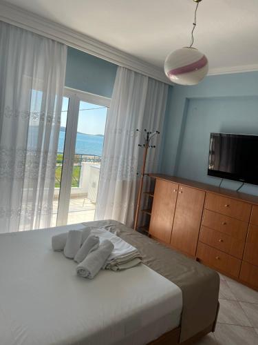a bedroom with a bed with a large window at Peramos Luxury 2 in Nea Peramos