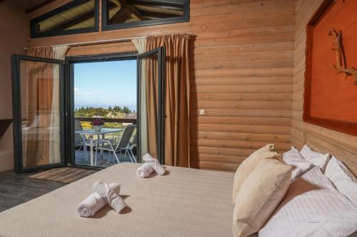 a bedroom with a bed with towels on it at Hilltop Chalet 2 in Hanioti