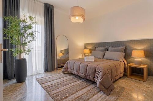 a bedroom with a bed and a potted plant at Casa della Civetta in Monopoli