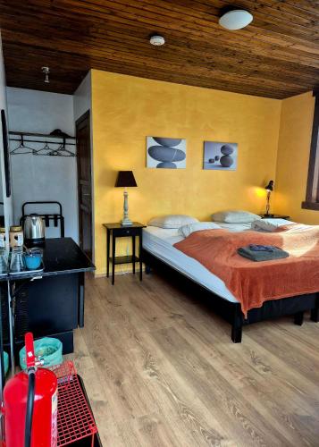 a bedroom with a large bed and a wooden ceiling at Guestroom with a mountain view in Laugarvatn