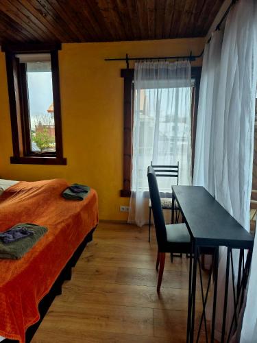 a bedroom with a bed and a table and window at Guestroom with a mountain view in Laugarvatn