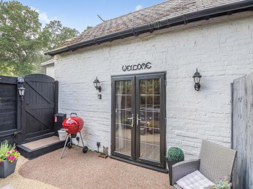 a white brick building with a glass door at Shire Cottage - Uk50416 in Bisterne