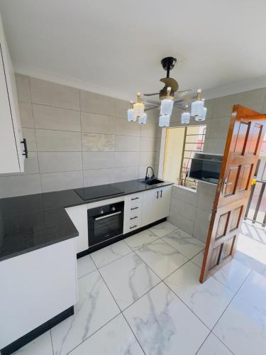 a kitchen with a counter and a stove top oven at Le Maire Gust Lodge in Johannesburg