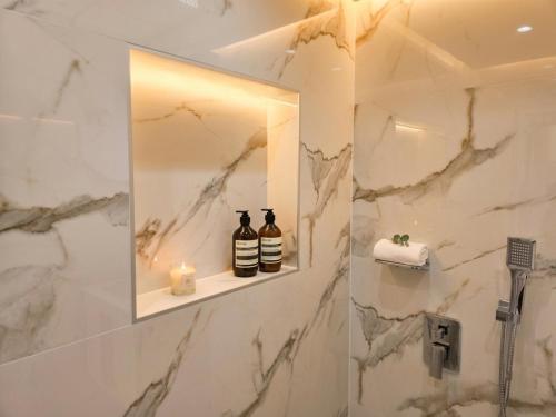 a bathroom with a mirror and a sink at Kasibel Suites in Sandanski