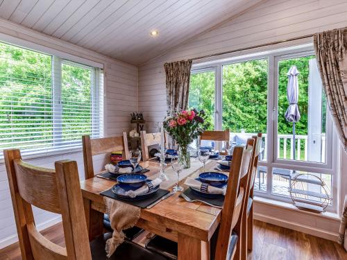 a dining room with a wooden table and chairs at Lavender Lodge in Derby