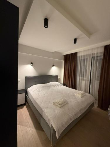 a bedroom with a large bed with white sheets at Cozy Newly Renovated Apartment in Batumi Old Town in Batumi