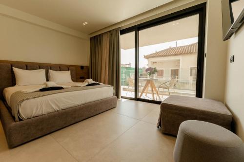 a bedroom with a bed and a large glass window at Aetheria South in Kourouta