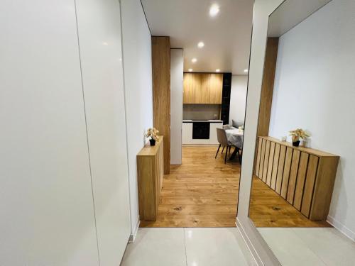 a hallway leading to a kitchen and a living room at Apartament white in Chişinău