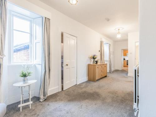a hallway with a table and a window at Church View in Hunstanton