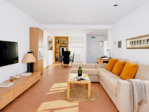 a living room with a white couch and a table at Casa Relax in Polop - Jacuzzi and Pool in Polop