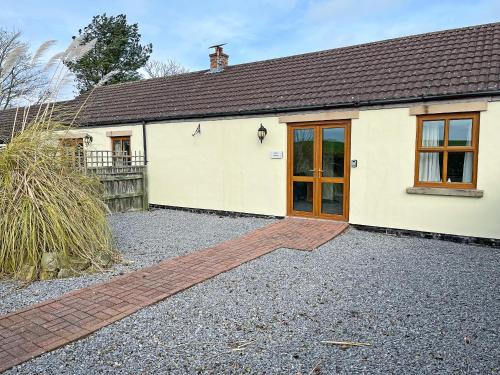a detached house with a garage and a driveway at Elder Cottage - Uk51371 in Winston