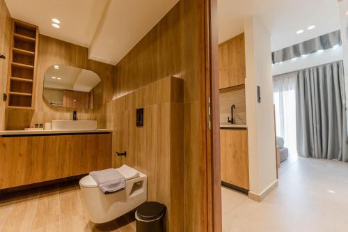 a bathroom with a toilet and a sink at Aetheria South in Kourouta