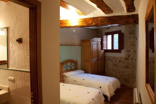 a bedroom with two beds in a room at Casa Abuelina in Titaguas