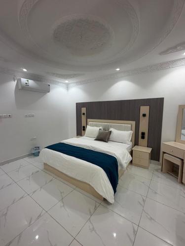 a bedroom with a large bed in a white room at رفاه الماسي in Medina