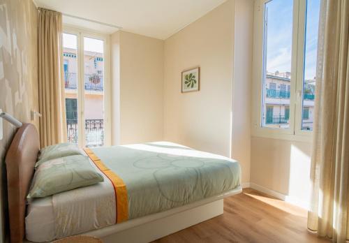 a bedroom with a bed and a window at Sul Corso Sanremo in Sanremo