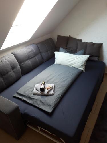 a large blue couch with a blanket on it at Haus Morgenstern Fewo Boben in Neuharlingersiel