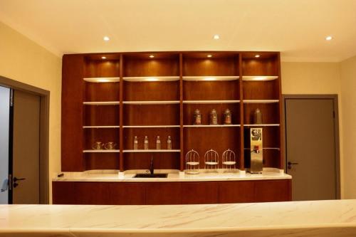 a kitchen with wooden shelves with glasses on it at AQMYRZA Inn in Zharkent