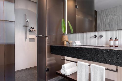 a bathroom with a sink and a mirror at Dorothea Hotel, Budapest, Autograph Collection in Budapest