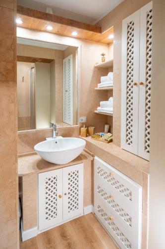 a bathroom with a sink and a mirror at Sul Corso Sanremo in Sanremo
