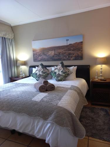 a bedroom with a bed with two towels on it at Forever Clarens in Clarens